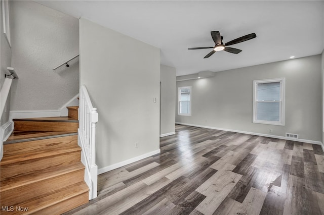 397 Furnace Rd, Conneaut, OH 44030 - unfurnished living room with stairs, wood finished floors, and ceiling fan