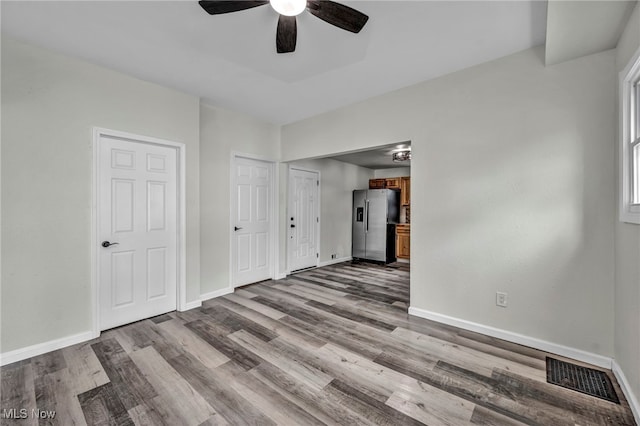 397 Furnace Rd, Conneaut, OH 44030 - unfurnished bedroom featuring stainless steel fridge, wood finished floors, and a ceiling fan