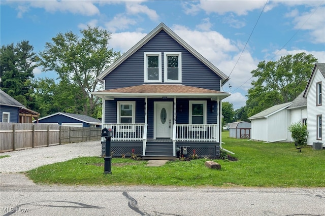 397 Furnace Rd, Conneaut, OH 44030 - view of front of house featuring a porch, a shed, and gravel driveway