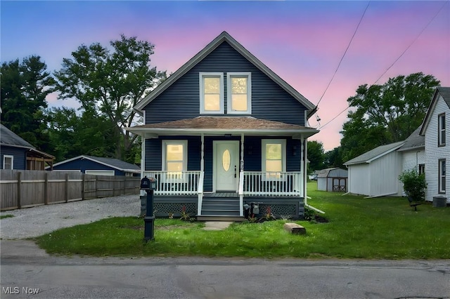 397 Furnace Rd, Conneaut, OH 44030 - view of front facade featuring a porch, a storage unit, and gravel driveway