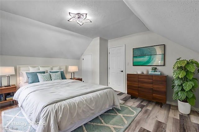 397 Furnace Rd, Conneaut, OH 44030 - bedroom featuring lofted ceiling, wood finished floors, and a textured ceiling