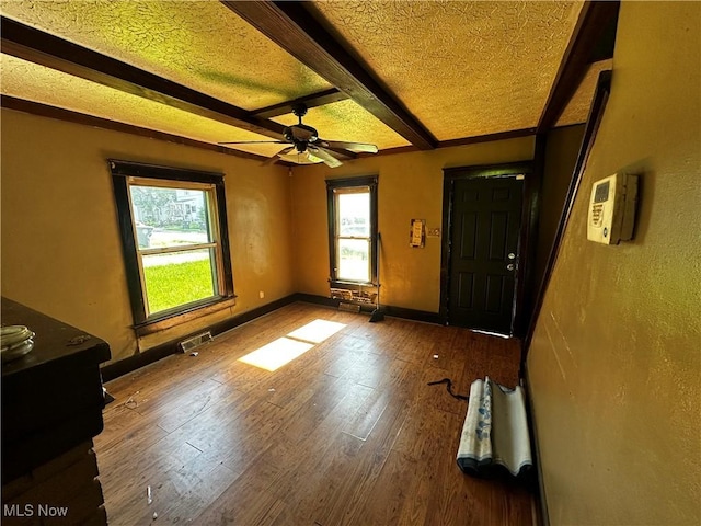 872 Keeney St, Akron, OH 44310 - entrance foyer featuring beamed ceiling, ceiling fan, wood finished floors, and a textured ceiling