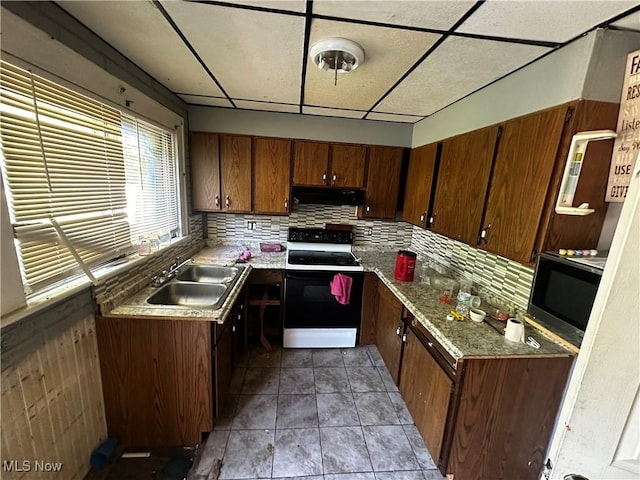 872 Keeney St, Akron, OH 44310 - kitchen featuring range with electric stovetop, under cabinet range hood, stainless steel microwave, brown cabinetry, and a drop ceiling