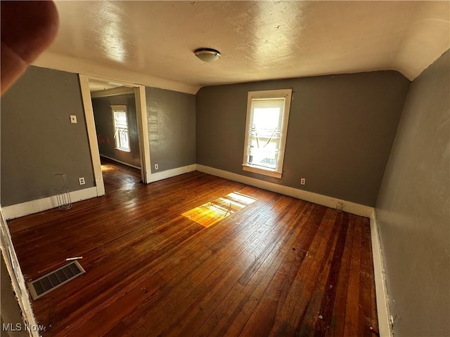 872 Keeney St, Akron, OH 44310 - empty room with vaulted ceiling and hardwood / wood-style flooring