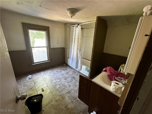 872 Keeney St, Akron, OH 44310 - bathroom featuring vanity, tile patterned floors, and wainscoting