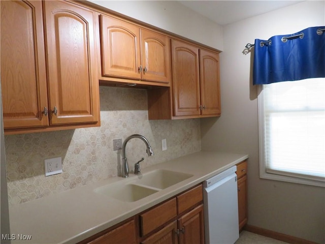 1609 S Main St Unit 22C, North Canton, OH 44709 - kitchen with white dishwasher, tasteful backsplash, light countertops, and brown cabinets