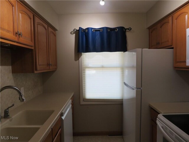 1609 S Main St Unit 22C, North Canton, OH 44709 - kitchen with white appliances, brown cabinets, tasteful backsplash, and light countertops