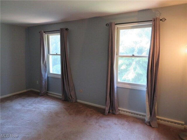 1609 S Main St Unit 22C, North Canton, OH 44709 - spare room with carpet and a baseboard radiator