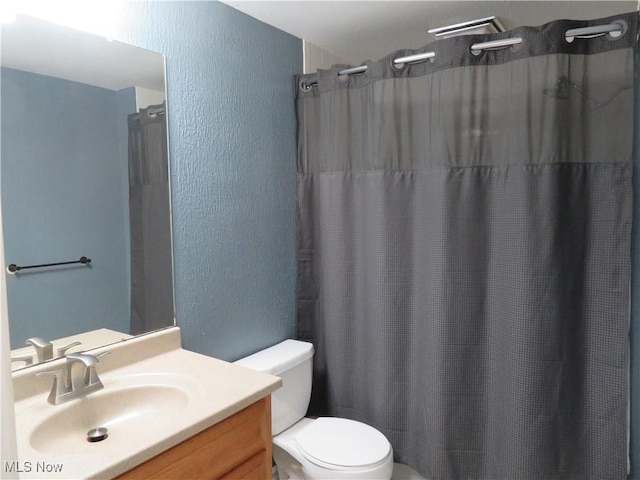 1609 S Main St Unit 22C, North Canton, OH 44709 - bathroom with a textured wall, vanity, and a shower with curtain