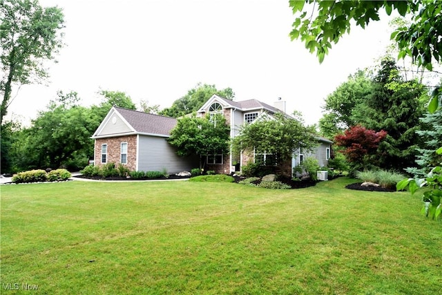 8025 Wadsworth Rd, Wadsworth, OH 44281 - view of front facade with a front lawn, a chimney, and brick siding