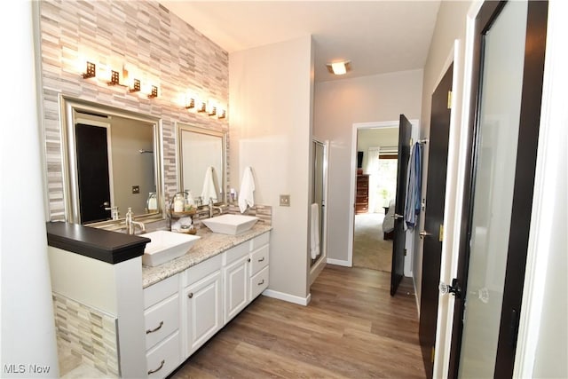 8025 Wadsworth Rd, Wadsworth, OH 44281 - full bathroom featuring double vanity, wood finished floors, and a stall shower