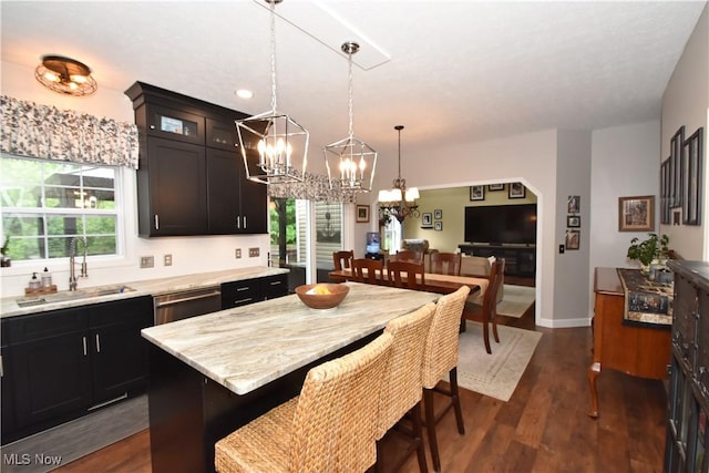 8025 Wadsworth Rd, Wadsworth, OH 44281 - kitchen with a chandelier, plenty of natural light, pendant lighting, and glass insert cabinets