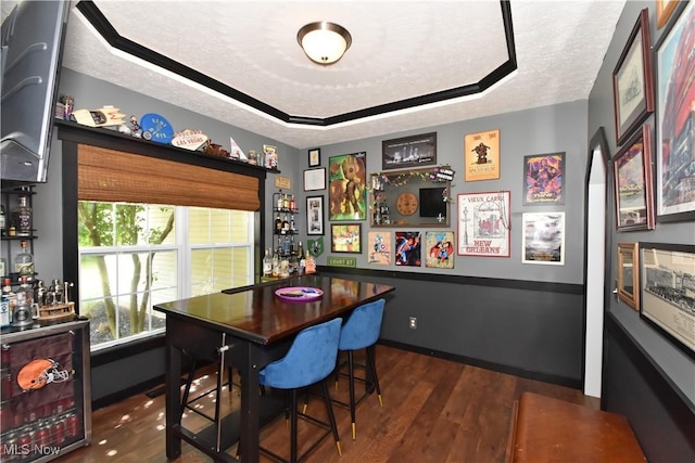 8025 Wadsworth Rd, Wadsworth, OH 44281 - dining area with dark wood-style flooring, a tray ceiling, and a textured ceiling