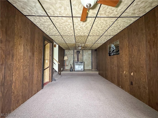 7918 State Route 164, Lisbon, OH 44432 - finished below grade area featuring carpet, wood walls, heating unit, a ceiling fan, and stairs