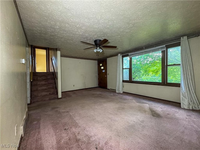 7918 State Route 164, Lisbon, OH 44432 - unfurnished living room with a ceiling fan, a textured ceiling, stairs, and carpet floors