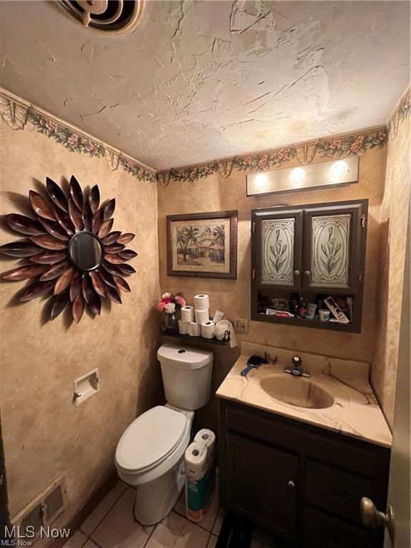 629 Willard Ave SE, Warren, OH 44483 - half bathroom featuring vanity and tile patterned flooring