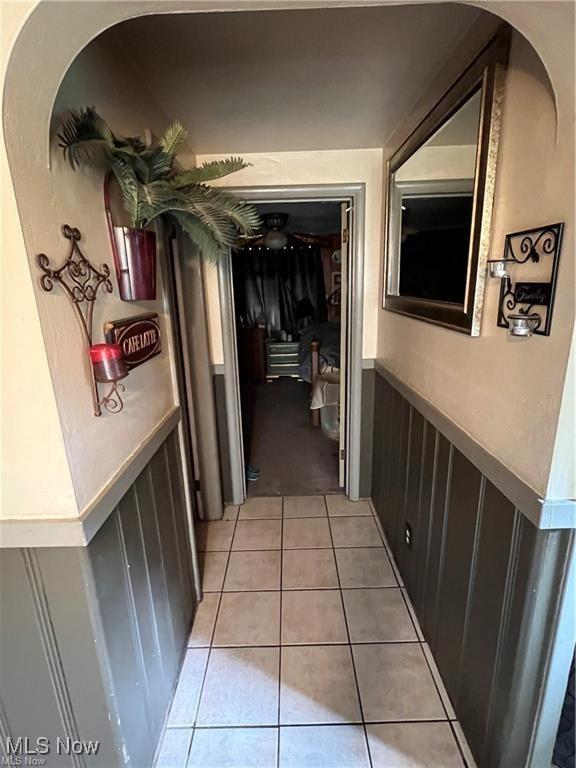 629 Willard Ave SE, Warren, OH 44483 - corridor with a wainscoted wall and light tile patterned floors