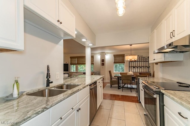13800 Fairhill Rd Unit 206, Shaker Heights, OH 44120 - kitchen featuring stainless steel appliances, under cabinet range hood, white cabinetry, light tile patterned floors, and recessed lighting
