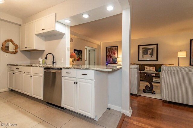 13800 Fairhill Rd Unit 206, Shaker Heights, OH 44120 - kitchen featuring dishwasher, light stone countertops, white cabinets, recessed lighting, and a peninsula
