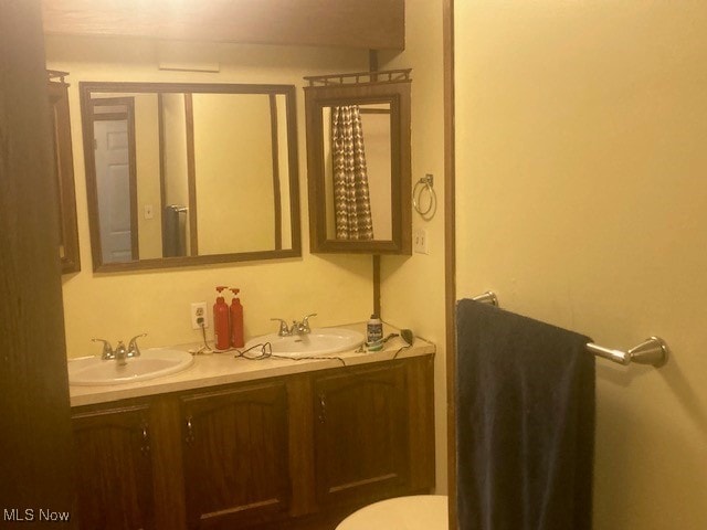 129 Bennett, Vienna, OH 44473 - bathroom with double vanity and toilet