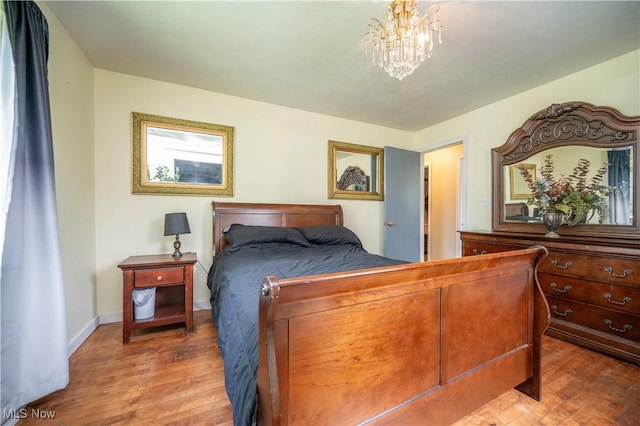 1432 Maxwell Ave NW, Warren, OH 44485 - bedroom featuring wood finished floors and a chandelier
