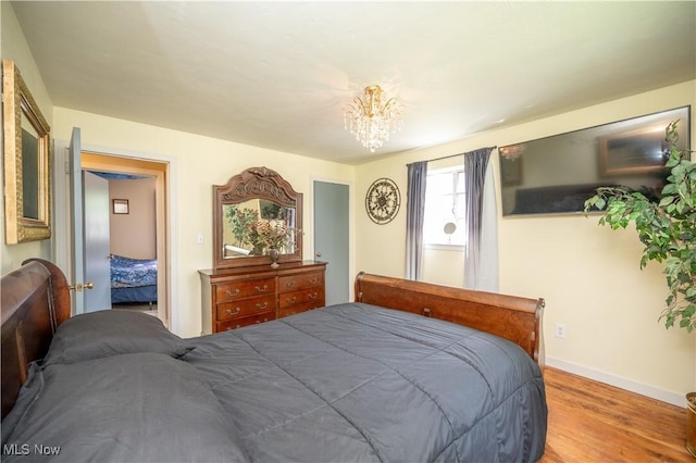 1432 Maxwell Ave NW, Warren, OH 44485 - bedroom featuring wood finished floors and a chandelier