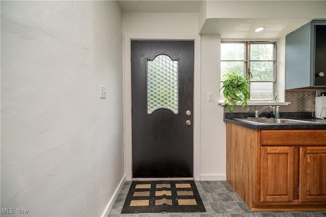 1432 Maxwell Ave NW, Warren, OH 44485 - doorway to outside with baseboards and a sink