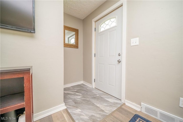 1432 Maxwell Ave NW, Warren, OH 44485 - foyer with light wood finished floors and a textured ceiling