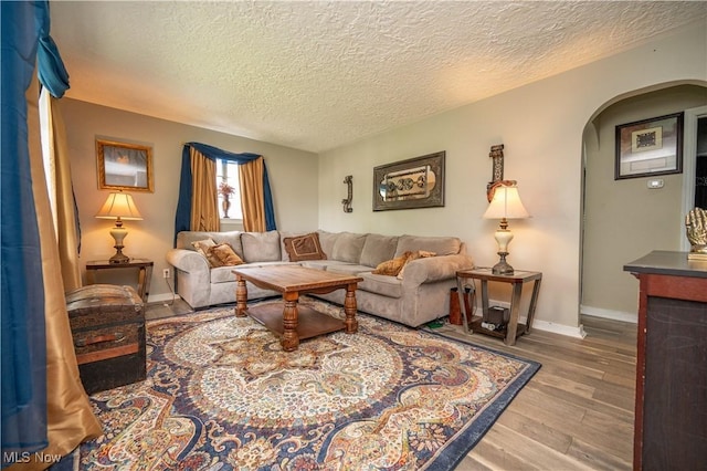 1432 Maxwell Ave NW, Warren, OH 44485 - living room with arched walkways, a textured ceiling, and wood finished floors