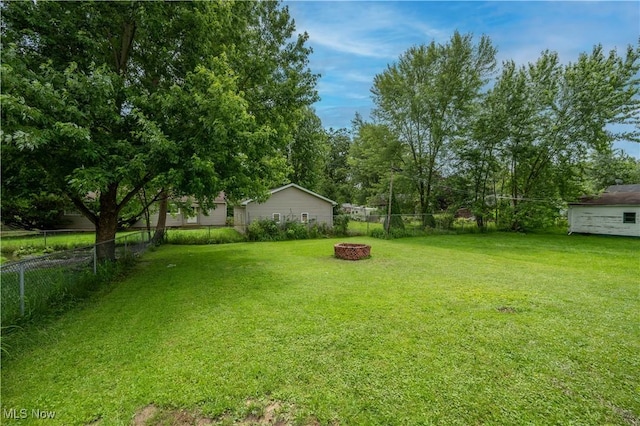1432 Maxwell Ave NW, Warren, OH 44485 - fenced backyard with an outdoor fire pit