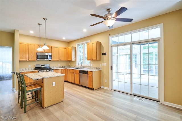 2683 High Hampton Trl, Cuyahoga Falls, OH 44223 - kitchen with appliances with stainless steel finishes, healthy amount of natural light, a center island, light wood-style floors, and recessed lighting