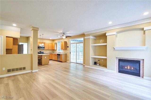2683 High Hampton Trl, Cuyahoga Falls, OH 44223 - unfurnished living room featuring light wood-style flooring, recessed lighting, a fireplace, ceiling fan, and built in shelves