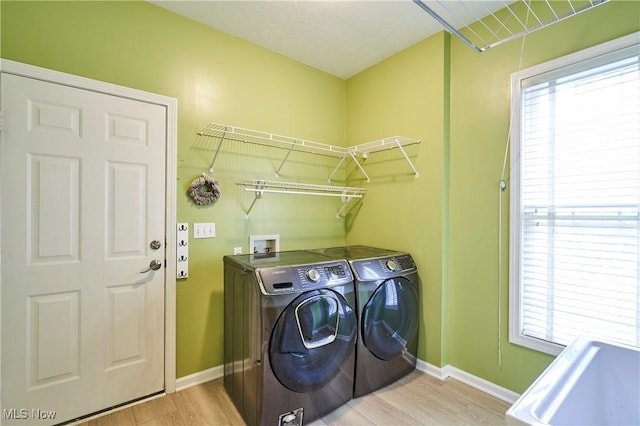 2683 High Hampton Trl, Cuyahoga Falls, OH 44223 - laundry area with washing machine and clothes dryer, light wood-style floors, and healthy amount of natural light