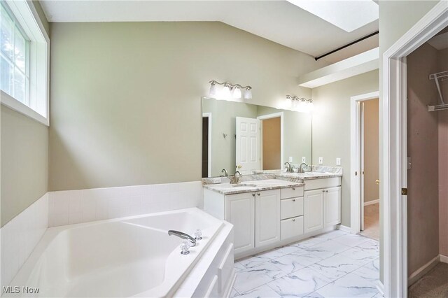 2683 High Hampton Trl, Cuyahoga Falls, OH 44223 - bathroom with double vanity, a garden tub, marble finish floors, and lofted ceiling