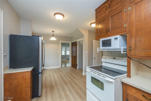 36 Rosedale Blvd, Norwalk, OH 44857 - kitchen featuring white appliances, brown cabinets, light wood finished floors, and light countertops