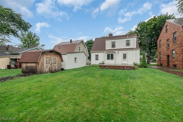 36 Rosedale Blvd, Norwalk, OH 44857 - back of house with a storage unit, a chimney, a lawn, and a deck