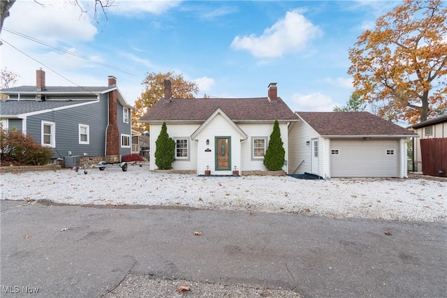 3568 Peninsula Dr, Coventry, OH 44319 - view of front of house with an attached garage and a chimney