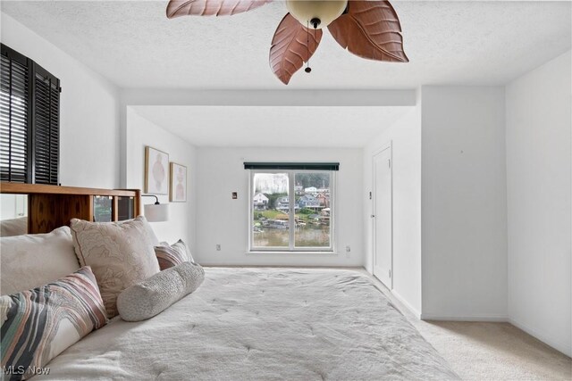 3568 Peninsula Dr, Coventry, OH 44319 - bedroom featuring carpet, a ceiling fan, and a textured ceiling
