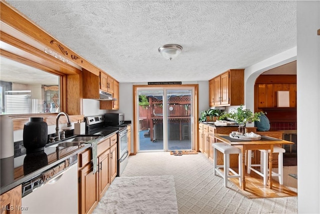 3568 Peninsula Dr, Coventry, OH 44319 - kitchen featuring stainless steel electric range, dishwasher, under cabinet range hood, dark countertops, and a textured ceiling