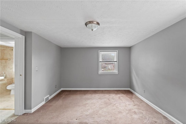 3568 Peninsula Dr, Coventry, OH 44319 - spare room with carpet floors and a textured ceiling