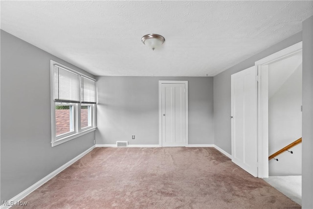 3568 Peninsula Dr, Coventry, OH 44319 - carpeted empty room featuring a textured ceiling