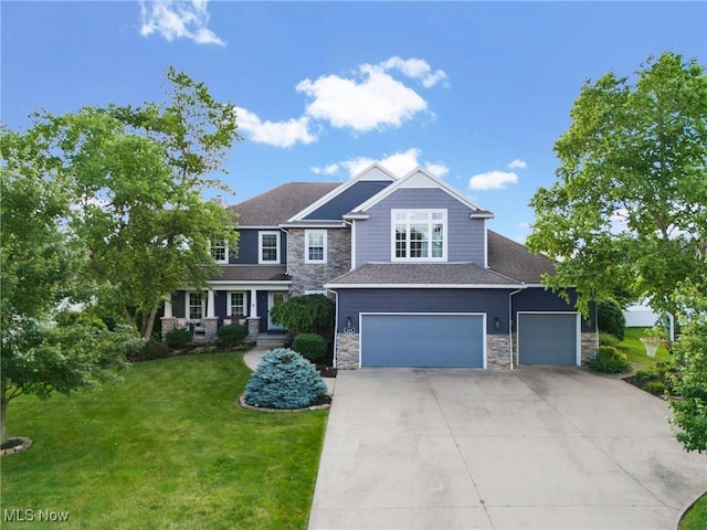 905 Braemar Cir, North Canton, OH 44720 - craftsman house with stone siding, driveway, a front lawn, an attached garage, and a garage