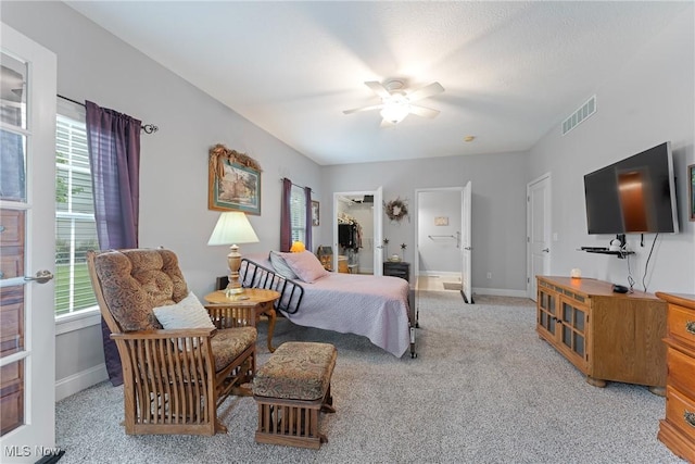 905 Braemar Cir, North Canton, OH 44720 - bedroom with light colored carpet, a ceiling fan, and a spacious closet
