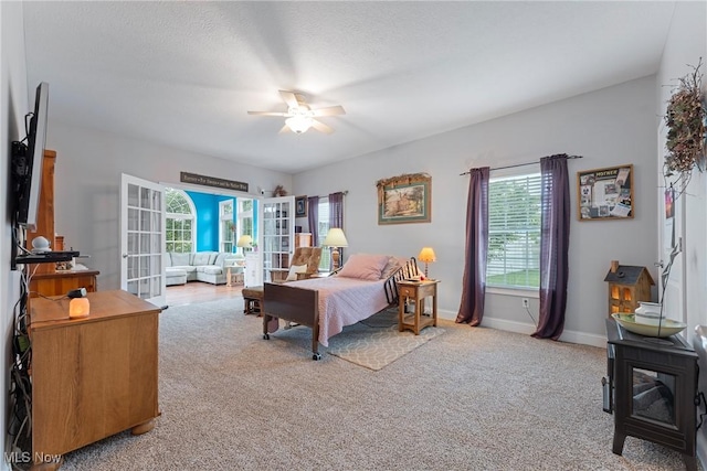905 Braemar Cir, North Canton, OH 44720 - carpeted bedroom with a wood stove, a ceiling fan, and french doors