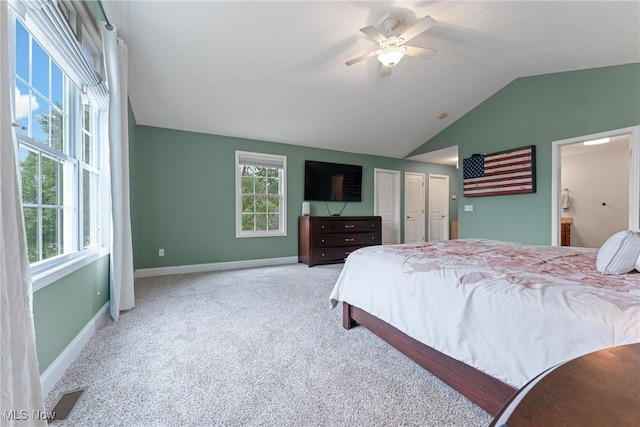 905 Braemar Cir, North Canton, OH 44720 - carpeted bedroom featuring multiple windows, lofted ceiling, ceiling fan, and ensuite bathroom