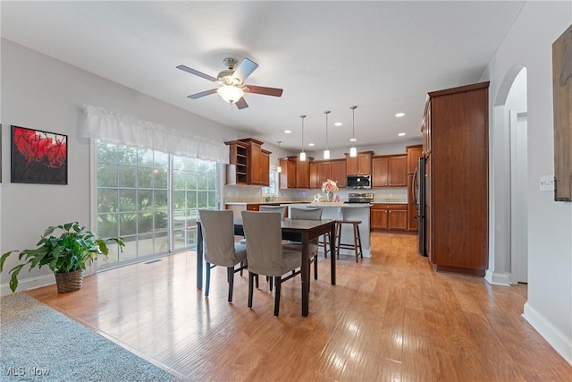 905 Braemar Cir, North Canton, OH 44720 - dining space with a ceiling fan, arched walkways, light wood-style floors, and recessed lighting