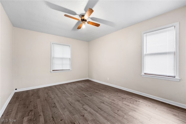 907 Hillsdale Ave, Parma, OH 44134 - spare room featuring dark wood-style floors and ceiling fan