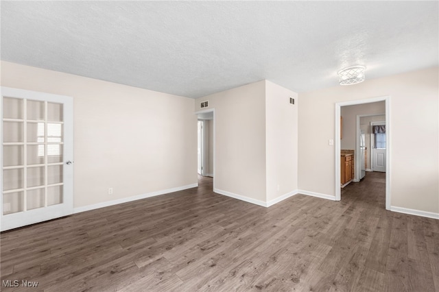 907 Hillsdale Ave, Parma, OH 44134 - spare room featuring wood finished floors and a textured ceiling