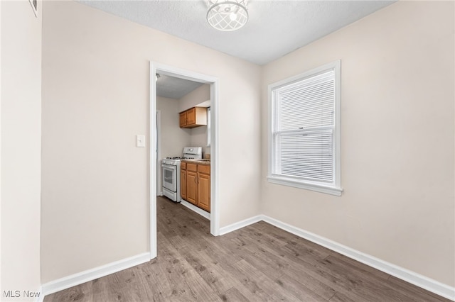 907 Hillsdale Ave, Parma, OH 44134 - unfurnished dining area with light wood-style flooring and baseboards