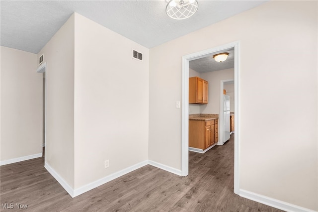 907 Hillsdale Ave, Parma, OH 44134 - spare room featuring light wood-type flooring and a textured ceiling